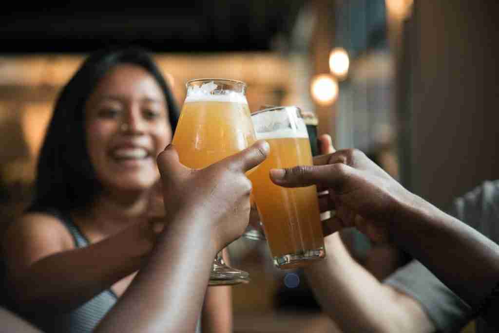 Is a group of friends toasting beer